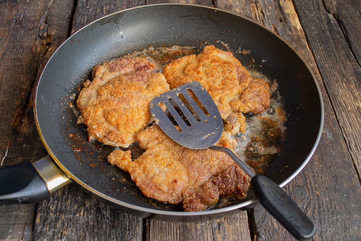 Gebakken varkensschnitzel in de pan.